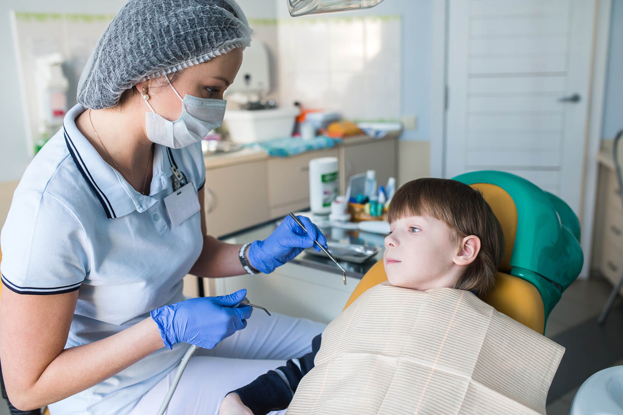 Lufkin Kids Dentistry Dental team smiling while sitting in conference room table