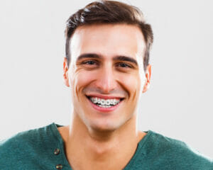 young man smiling after getting dental braces in Lufkin