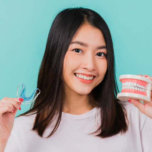 female teenager smiling after taking her Vivera retainers out